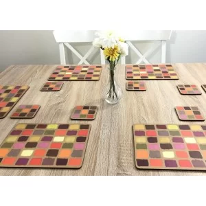 Wooden dining table. Corkbacked funky placemats colourful Harlequin pattern.