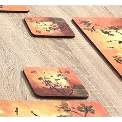 Close up view of Plymouth Sunset design drinks coasters on wooden dining table