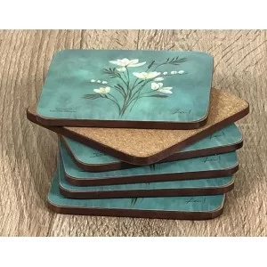 Infinity corkbacked floral coasters fanned out with base displayed