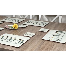 Wooden table with Penguin Parade bird themed cork backed tablemats