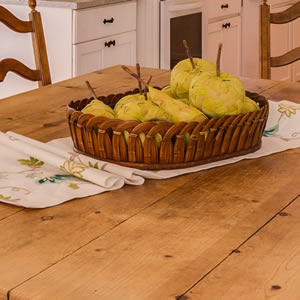 bowl of apples and pears on wooden dining table
